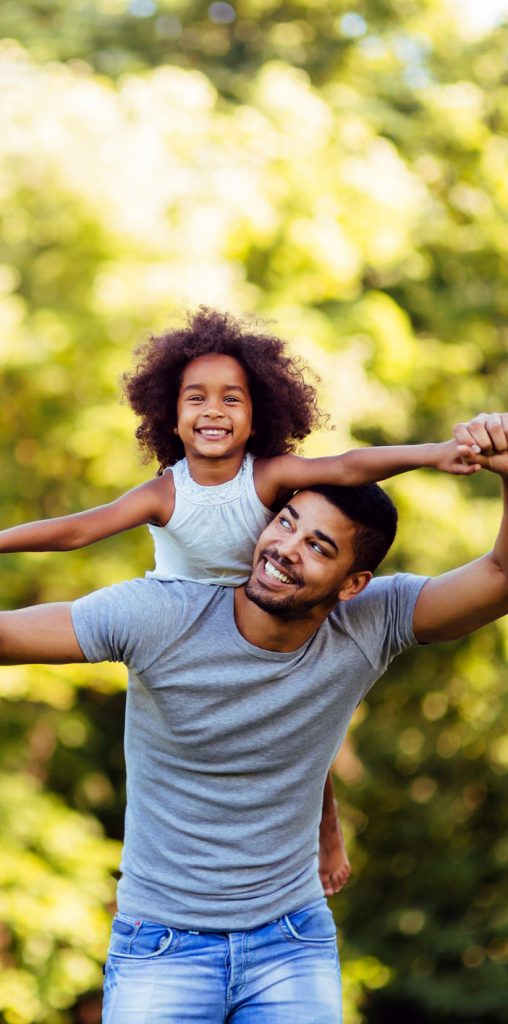 happy daughter on smiling dad's back